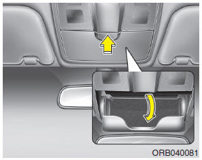 To open the sunglass holder, press the cover and the holder will slowly open.