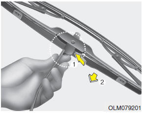 2. Compress the clip and slide the blade assembly downward.