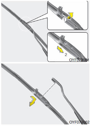 2. Lift up the wiper blade clip. Then pull down the blade assembly and remove