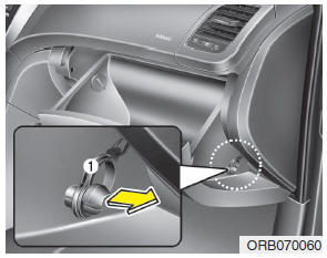 1. Open the glove box and remove the support strap (1).