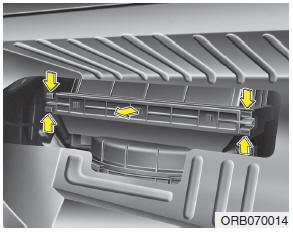 3. Remove the climate control air filter cover while pressing the lock of the